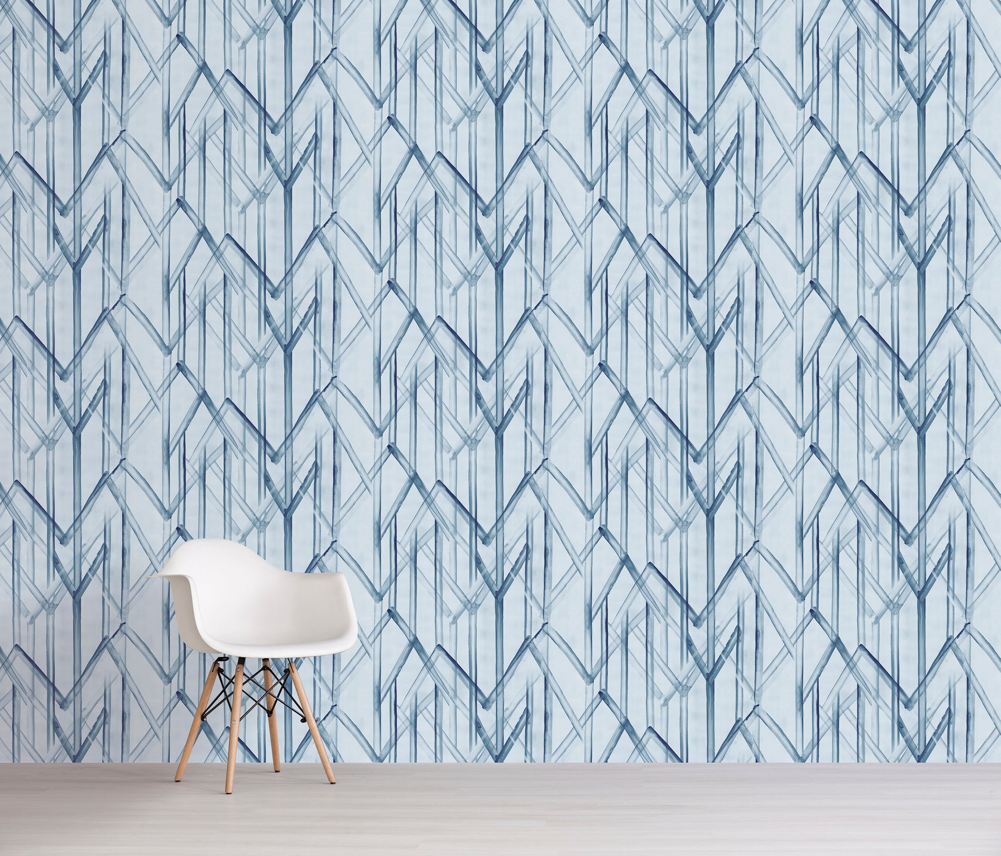 White chair in front of a wall with blue geometric pattern