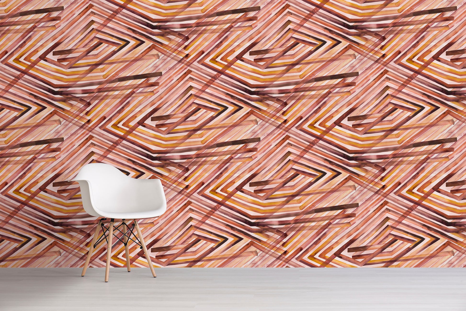 White chair in front of a wall with an orange geometric pattern