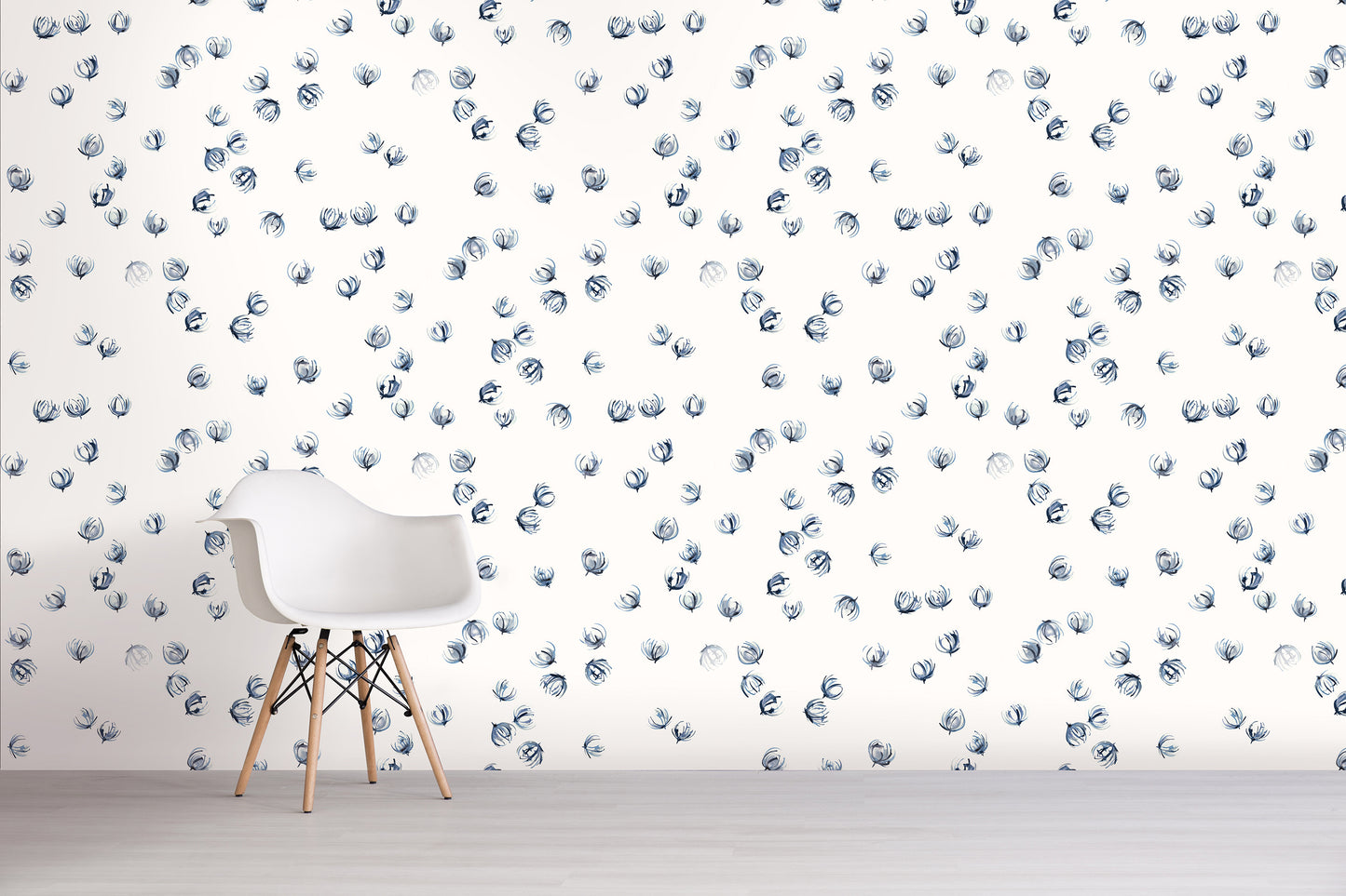 White chair in front of a wall with blue floral pattern