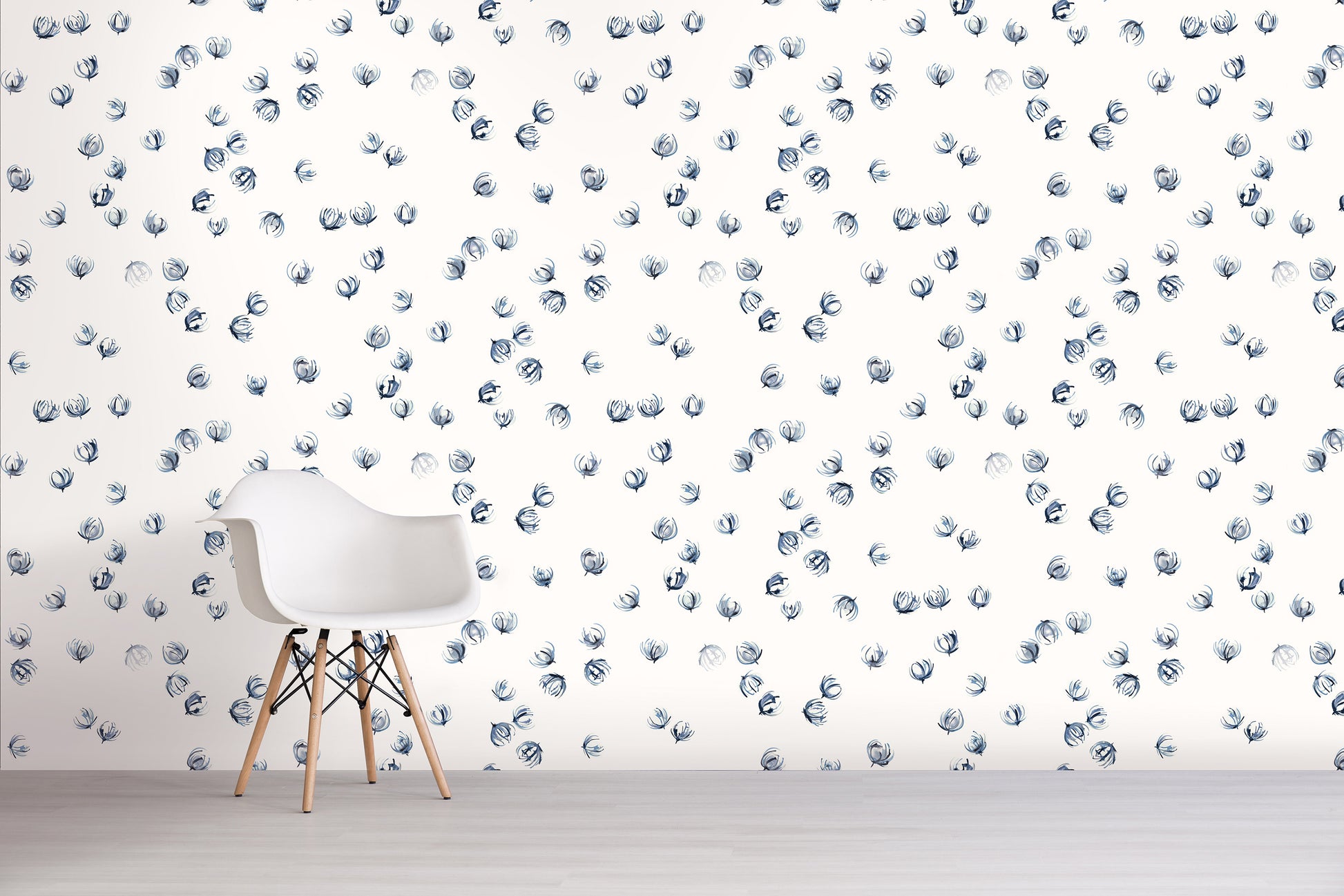 White chair in front of a wall with blue floral pattern