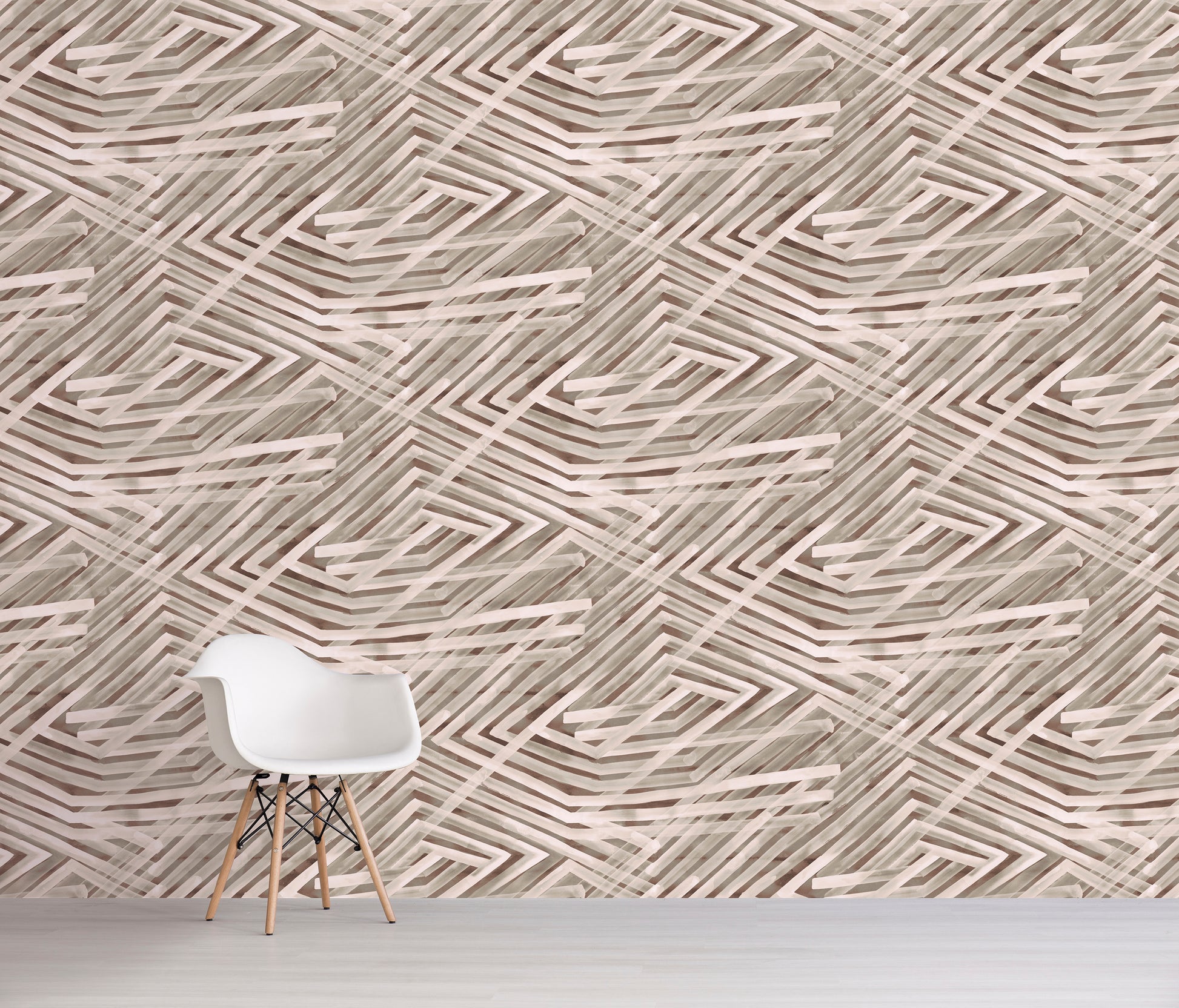 White chair in front of a wall with brown geometric patterned wallpaper