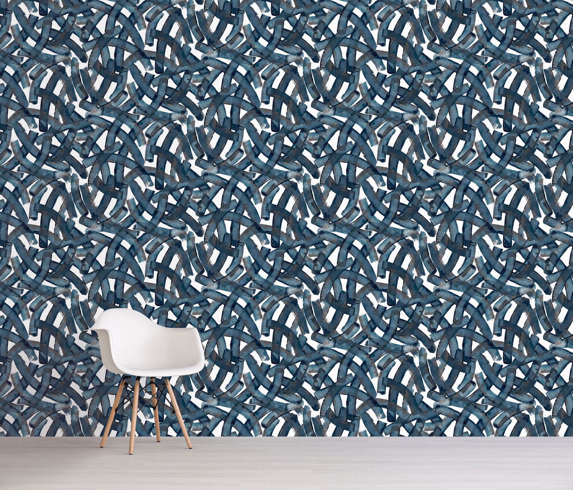 Wall with blue abstract pattern and a white chair in front