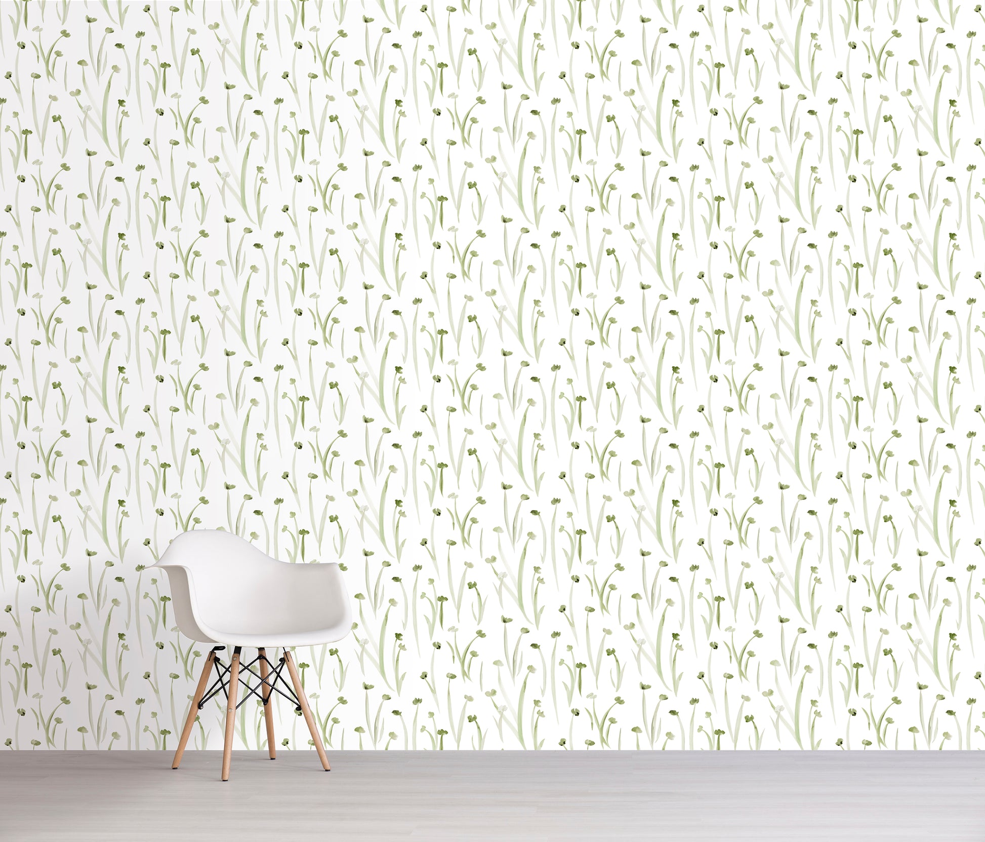 Wallpaper with subtle green floral pattern on a white wall with a chair in front.