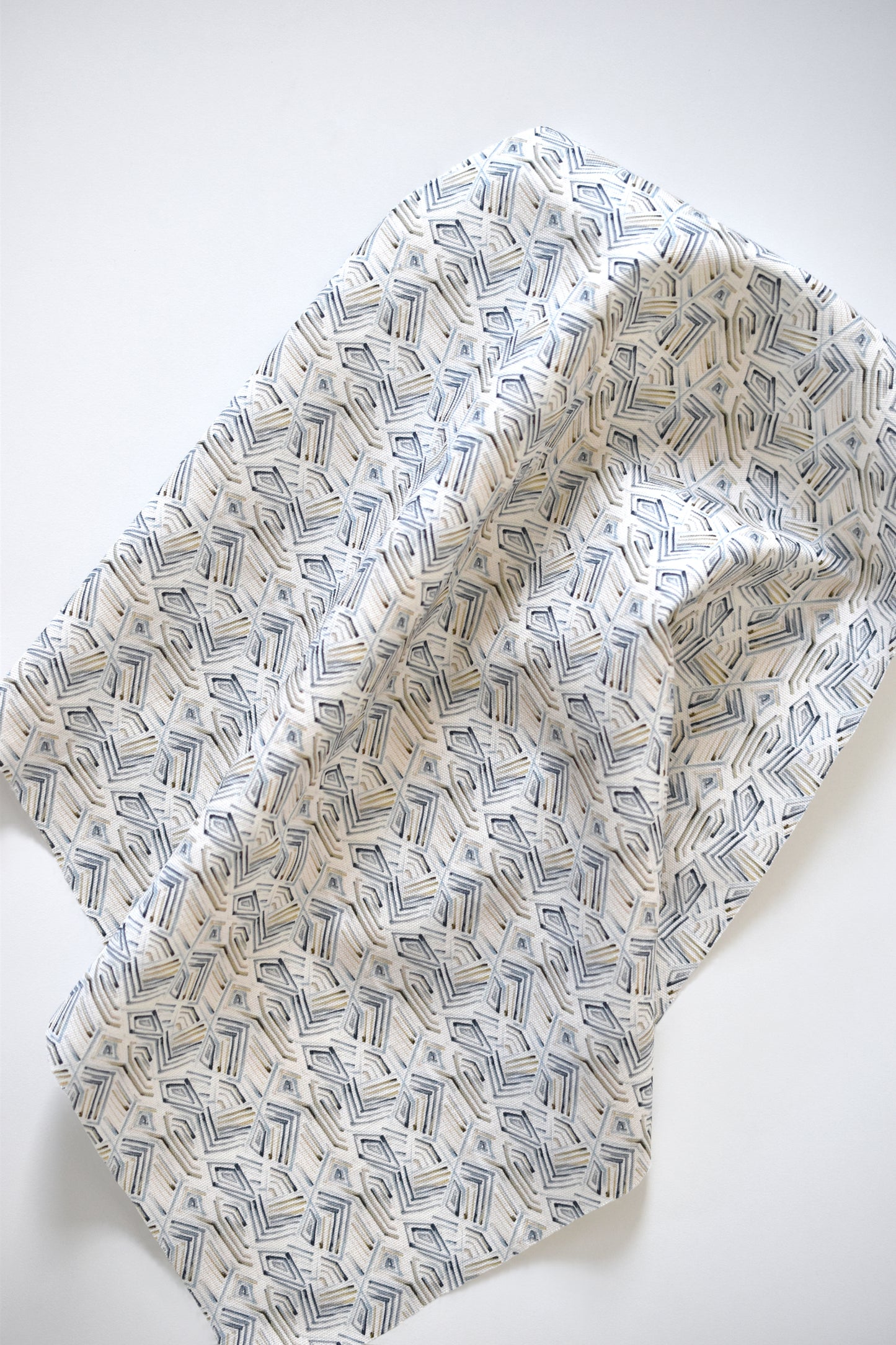 Folded fabric with geometric pattern on a white background