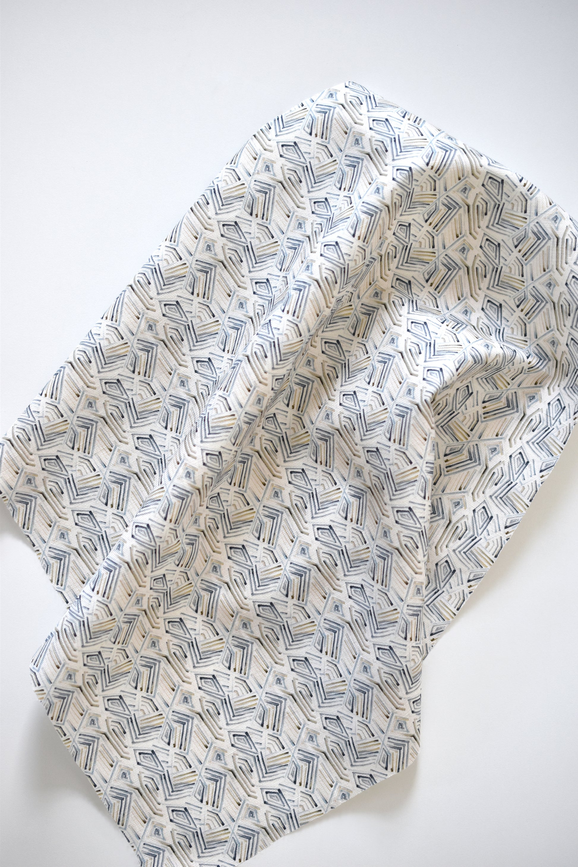 Folded fabric with geometric pattern on a white background