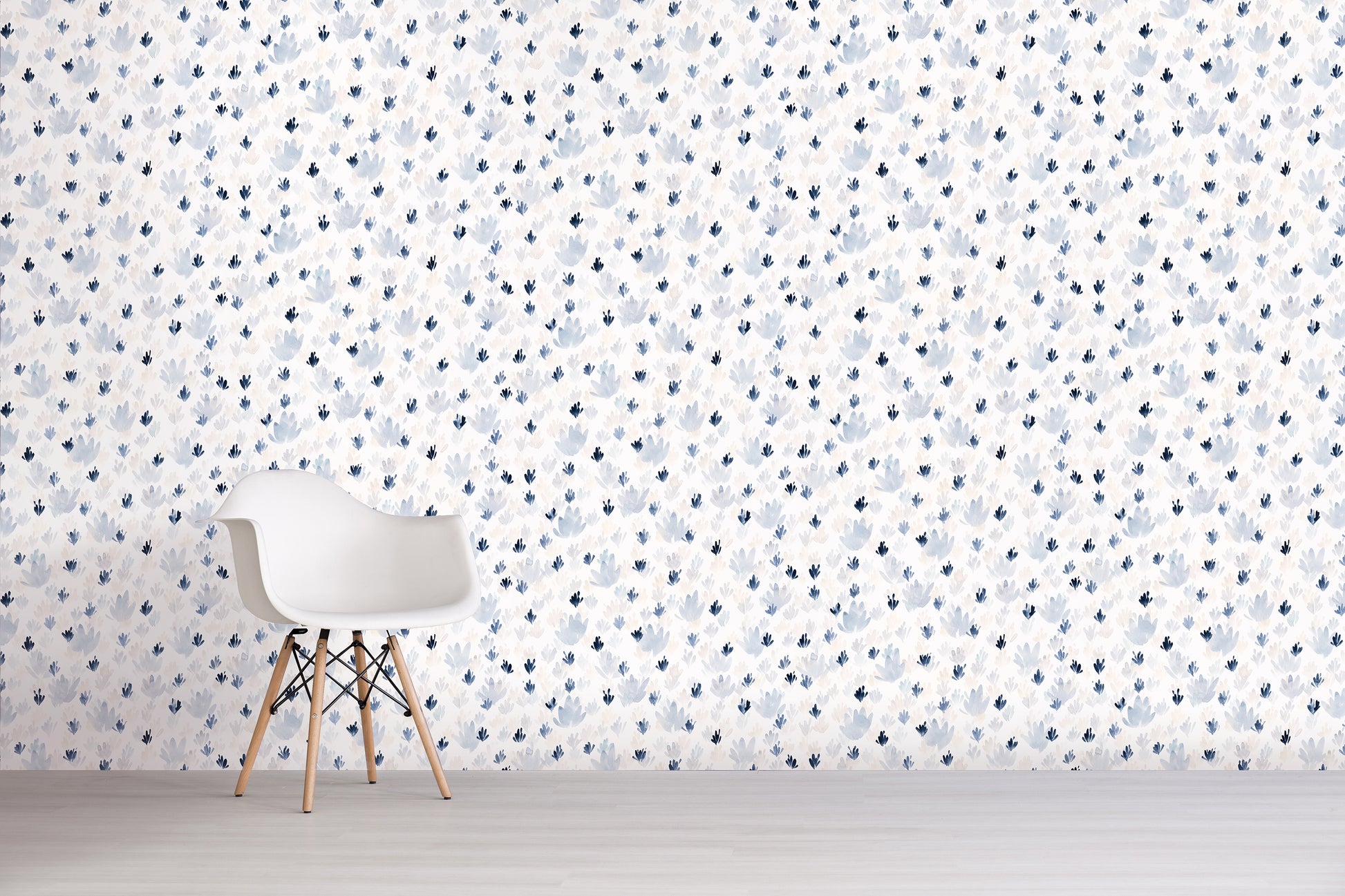 White chair in front of a wall with a subtle blue floral pattern