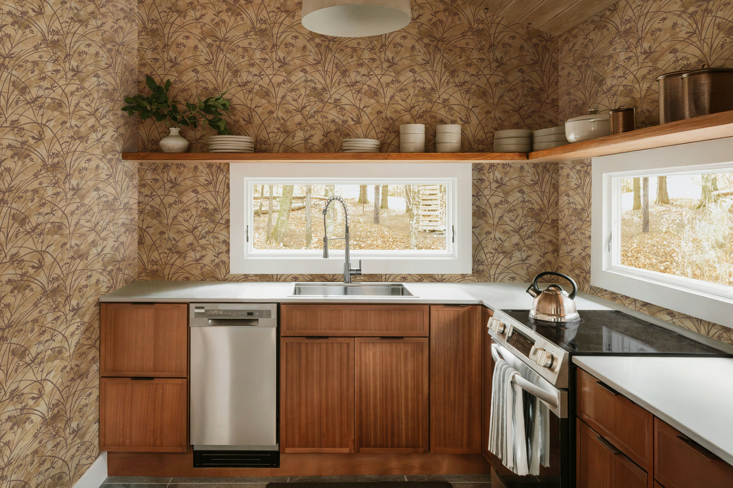 Modern kitchen with wooden cabinets, stainless steel appliances, and a window view.