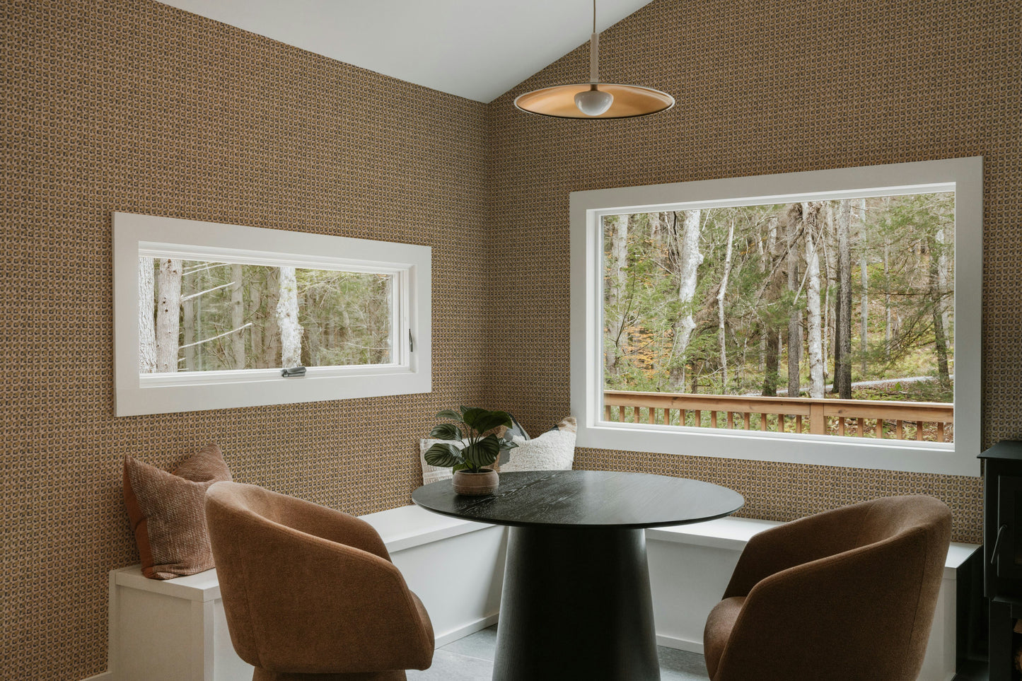 Dining room with brown walls, a round table, and two chairs.