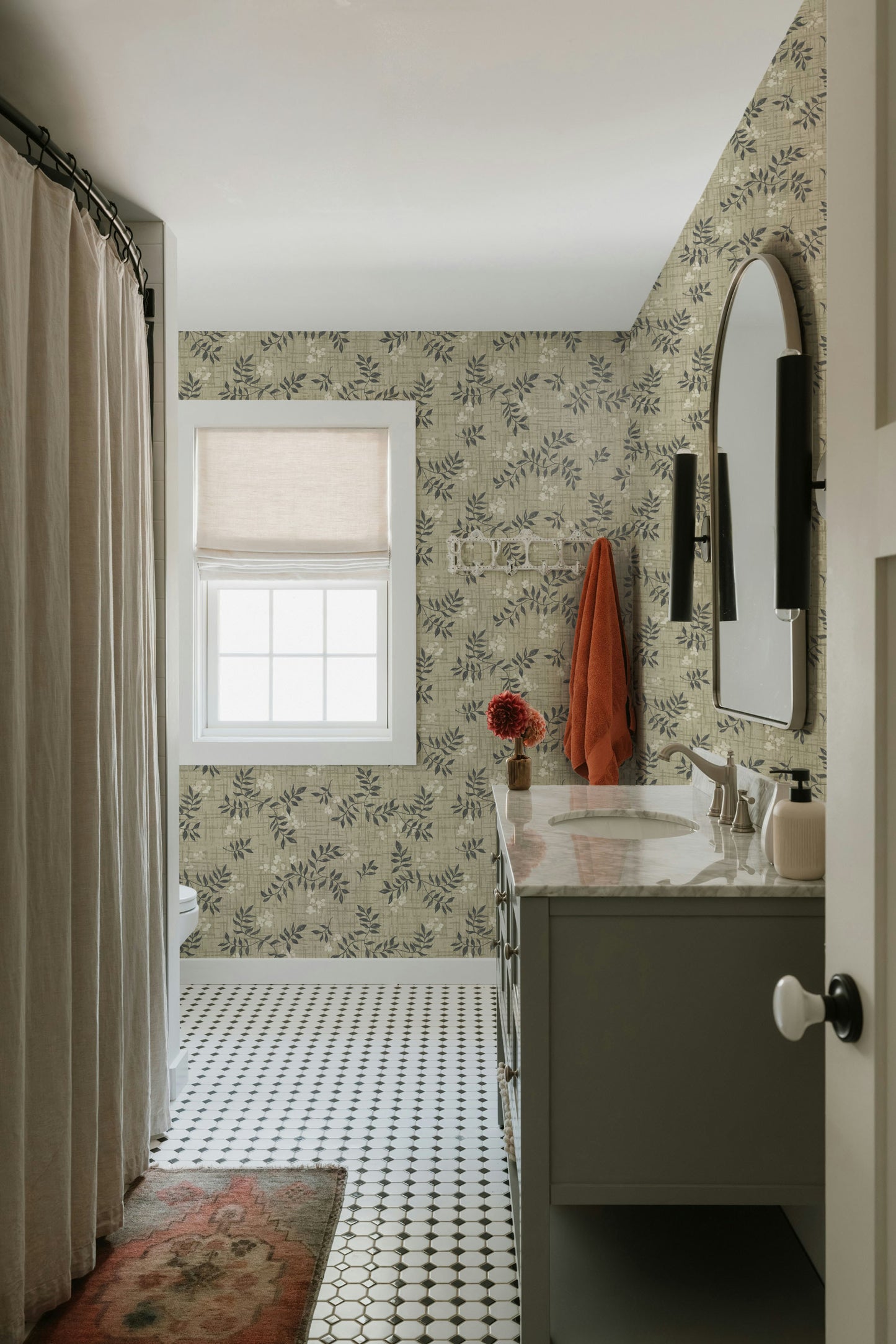 Bathroom with floral wallpaper, sink, and window