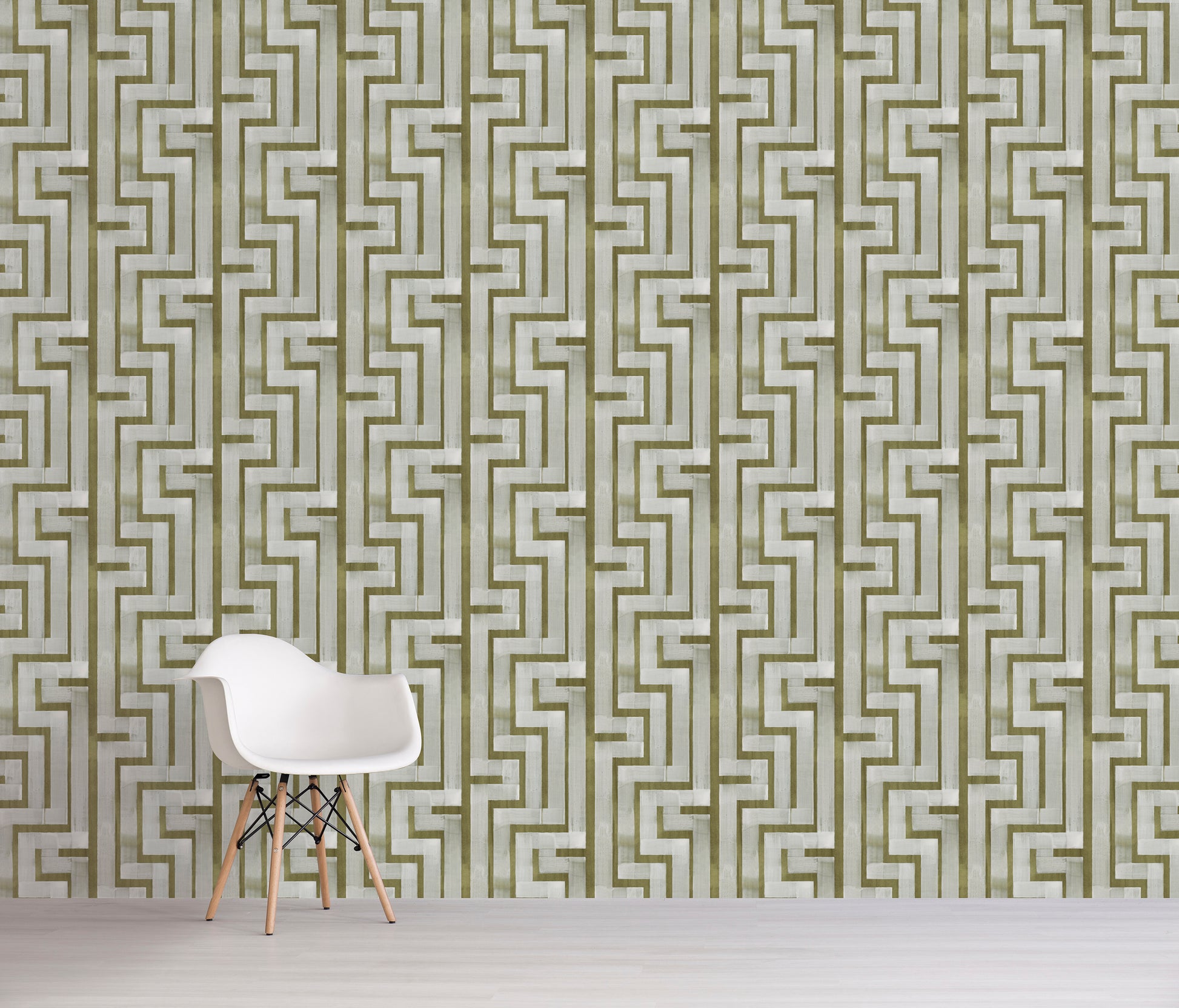 White chair in front of a green geometric patterned wall.