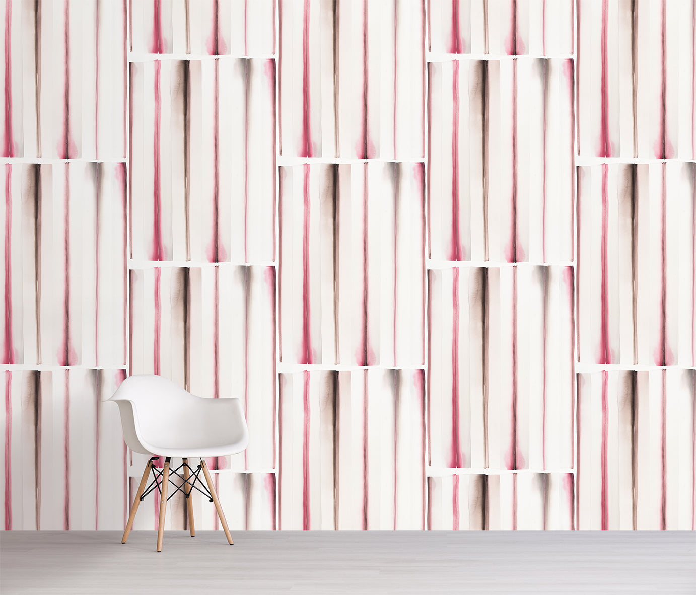 White chair in front of a wall with pink and white striped pattern