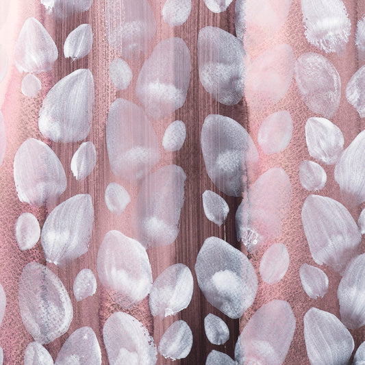 Close-up of white orb patterns on a pink background