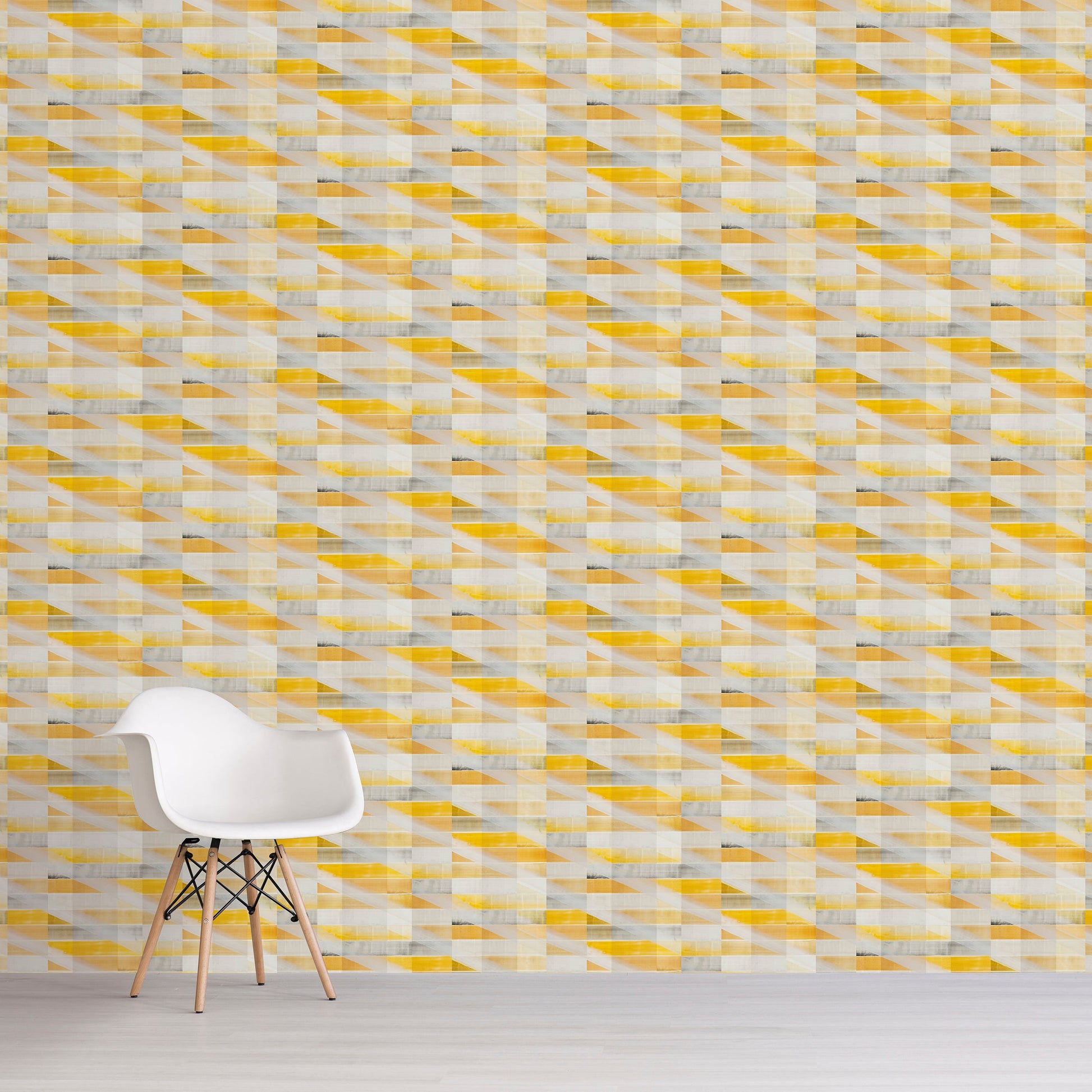 Yellow and grey tile pattern on wall with white chair