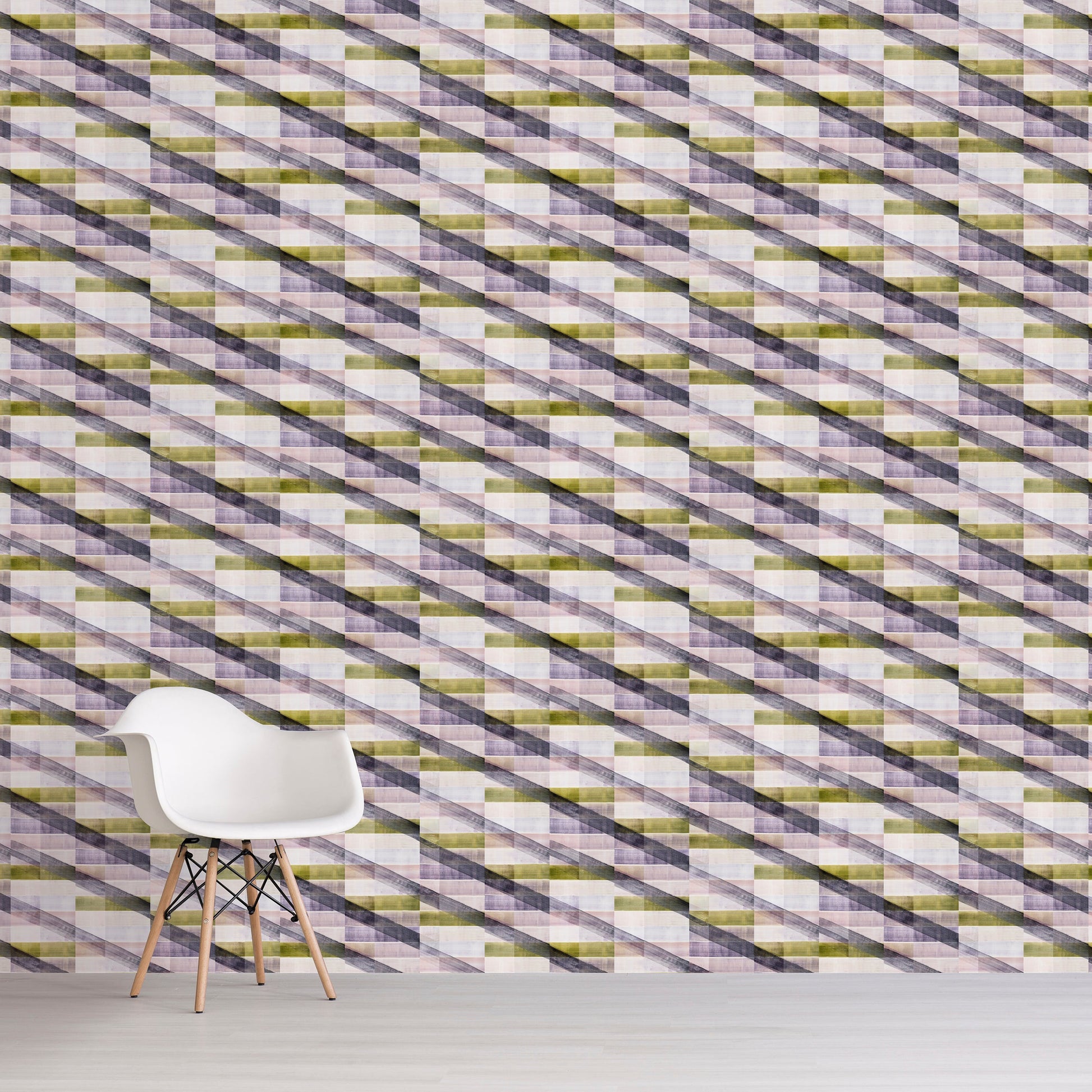 Patterned wall with geometric design in green, purple, and white, featuring a white chair in front.