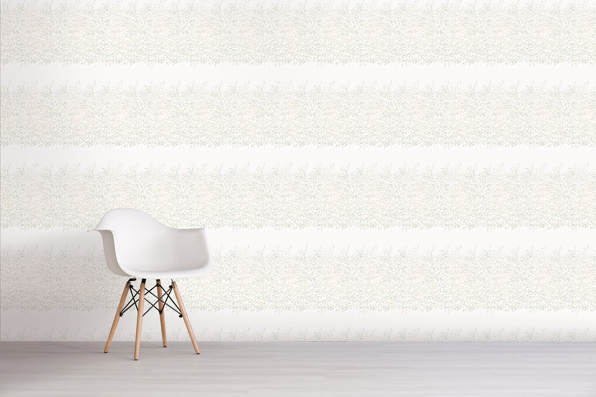 White chair against a green floral textured white wall