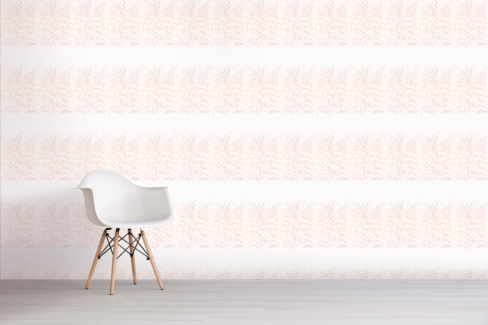 White chair with wooden legs against a light pink textured wall.