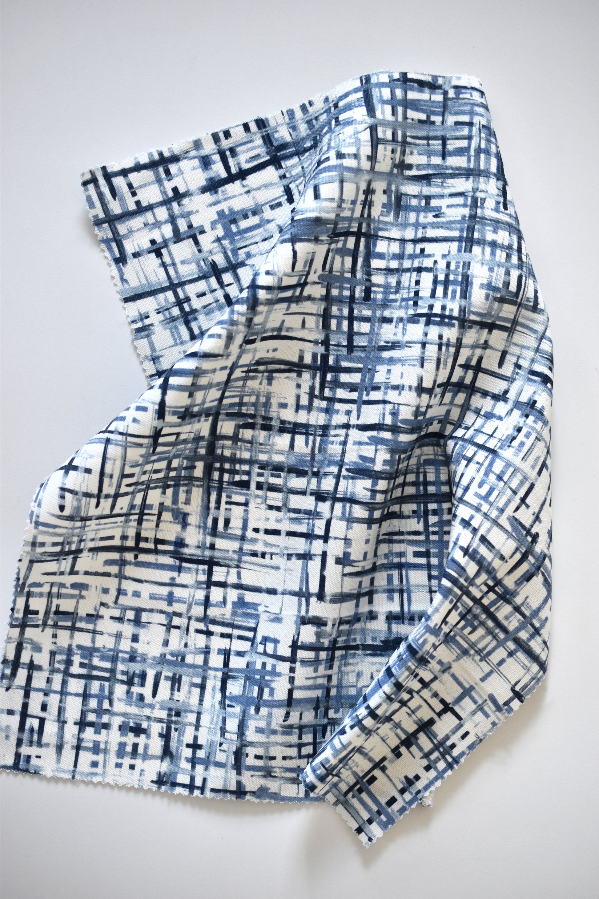 Blue and white patterned fabric on a light gray background
